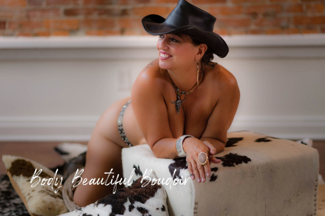 Cowgirl Boudoir Photography on Cow Print Stool