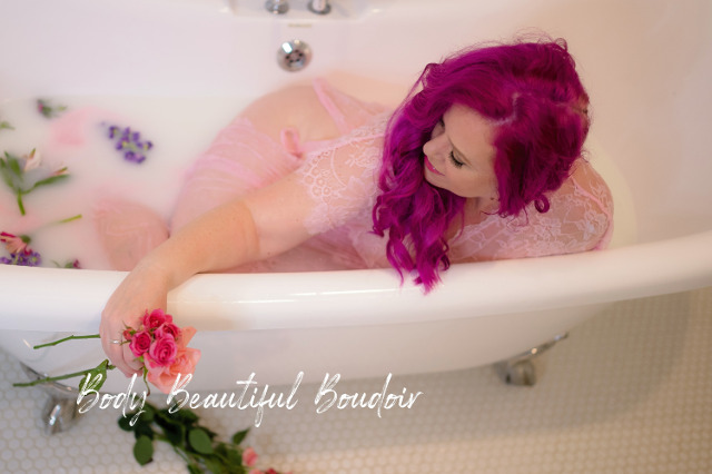 Woman in a milk bath with flowers