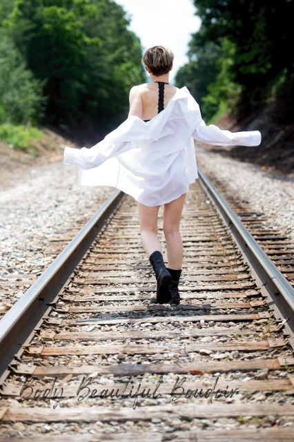 White shirt and combat boots on the railroad