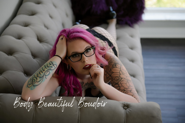 Beautiful woman with tattoos on couch
